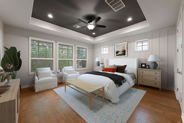 433 Chitalpa St, Leander, TX 78641 - bedroom with a tray ceiling, hardwood / wood-style flooring, multiple windows, and baseboards