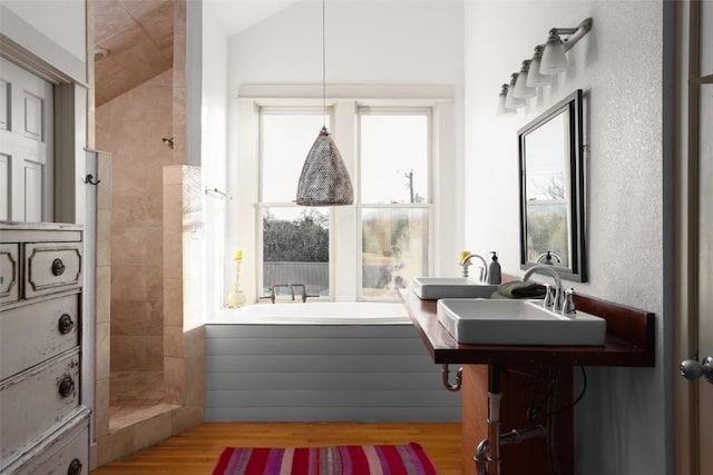 1313 W 9th 1/2 St, Austin, TX 78703 - bathroom featuring a garden tub, tiled shower, wood finished floors, and lofted ceiling