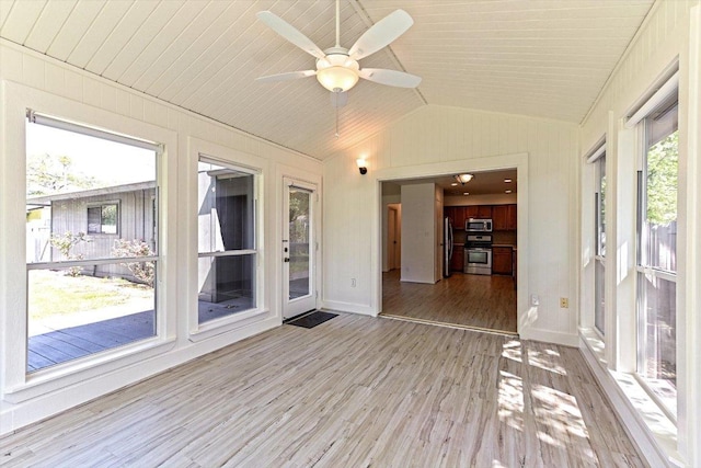 5003 Wing Rd, Austin, TX 78749 - unfurnished sunroom featuring lofted ceiling, wood finished floors, baseboards, and wood walls