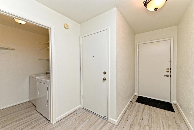5003 Wing Rd, Austin, TX 78749 - laundry area with light wood finished floors, washer and clothes dryer, and baseboards