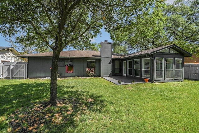 5003 Wing Rd, Austin, TX 78749 - rear view of property with a chimney and a sunroom
