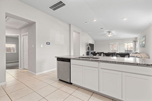 13801 Rosebud Isle Dr, Manor, TX 78653 - kitchen with stainless steel dishwasher, a sink, a ceiling fan, light stone counters, and white cabinetry