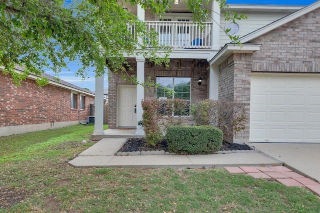 13605 Lyndon B Johnson St, Manor, TX 78653 - property entrance with a balcony, brick siding, an attached garage, and a yard