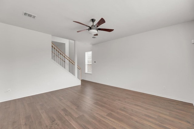 13605 Lyndon B Johnson St, Manor, TX 78653 - unfurnished living room with wood finished floors, a ceiling fan, stairway, and baseboards