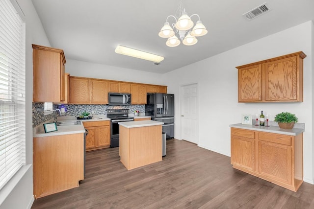 13605 Lyndon B Johnson St, Manor, TX 78653 - kitchen featuring electric stove, black microwave, fridge with ice dispenser, decorative backsplash, and dark wood finished floors