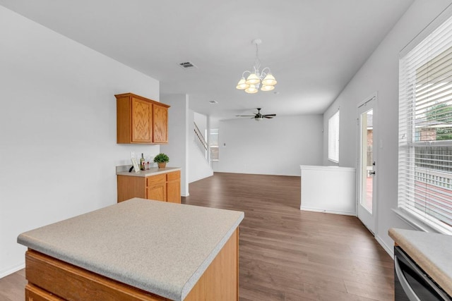 13605 Lyndon B Johnson St, Manor, TX 78653 - kitchen featuring a chandelier, wood finished floors, dishwasher, light countertops, and pendant lighting