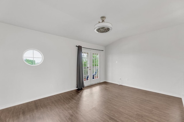 13605 Lyndon B Johnson St, Manor, TX 78653 - unfurnished room with dark wood-style floors, vaulted ceiling, baseboards, and french doors