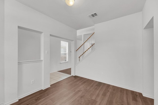 13605 Lyndon B Johnson St, Manor, TX 78653 - spare room with wood finished floors, stairway, and baseboards