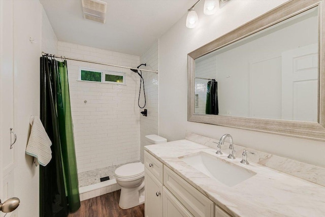9106 Slayton Dr, Austin, TX 78753 - bathroom featuring toilet, vanity, a shower stall, and wood finished floors