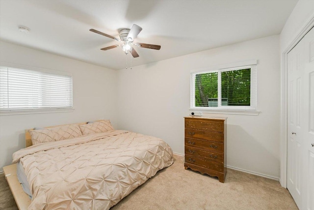 9106 Slayton Dr, Austin, TX 78753 - bedroom with a closet, light carpet, and a ceiling fan
