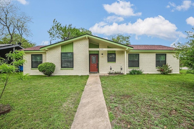 9106 Slayton Dr, Austin, TX 78753 - view of front facade featuring a front lawn and brick siding