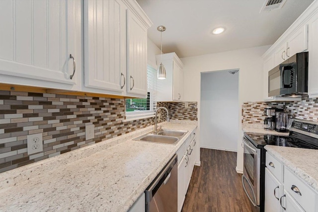 9106 Slayton Dr, Austin, TX 78753 - kitchen featuring stainless steel appliances, a sink, white cabinetry, dark wood-style flooring, and recessed lighting