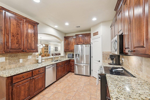 2004 American Dr Unit 1, Lago Vista, TX 78645 - kitchen featuring stainless steel appliances, a sink, arched walkways, tasteful backsplash, and recessed lighting