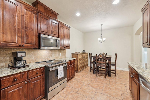 2004 American Dr Unit 1, Lago Vista, TX 78645 - kitchen featuring appliances with stainless steel finishes, backsplash, stone tile flooring, recessed lighting, and light stone counters