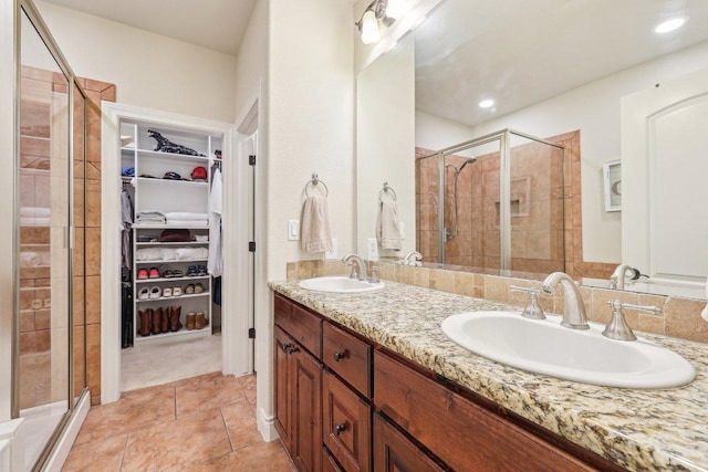 2004 American Dr Unit 1, Lago Vista, TX 78645 - bathroom featuring a shower stall, double vanity, a spacious closet, and tile patterned flooring