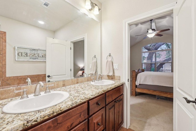 2004 American Dr Unit 1, Lago Vista, TX 78645 - bathroom featuring double vanity, ensuite bathroom, ceiling fan, and lofted ceiling