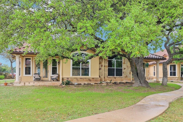 2004 American Dr Unit 1, Lago Vista, TX 78645 - view of front of home featuring a front yard, stucco siding, and a tiled roof