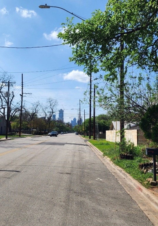 2904 E 2nd St, Austin, TX 78702 - view of asphalt road featuring curbs and street lights