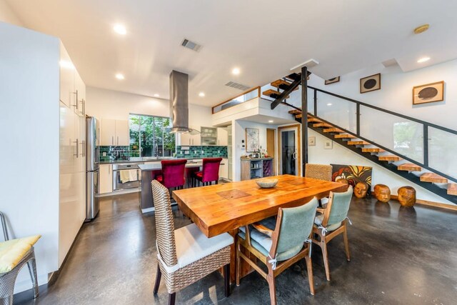 1902 Alegria Rd Unit B, Austin, TX 78757 - dining room featuring finished concrete flooring, stairway, and recessed lighting