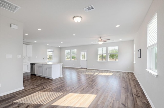 12103 Tolson Dr, Manor, TX 78653 - unfurnished living room featuring wood finished floors, a ceiling fan, and recessed lighting