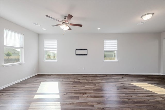 12103 Tolson Dr, Manor, TX 78653 - empty room with plenty of natural light, wood finished floors, a ceiling fan, and recessed lighting