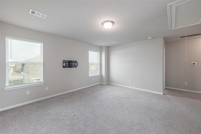 12103 Tolson Dr, Manor, TX 78653 - spare room featuring carpet floors and attic access