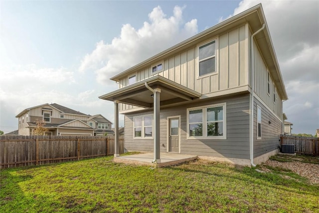 12103 Tolson Dr, Manor, TX 78653 - back of property featuring board and batten siding, a patio area, and a fenced backyard
