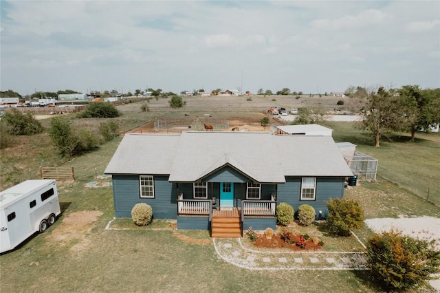 view of front of house with covered porch and a front lawn