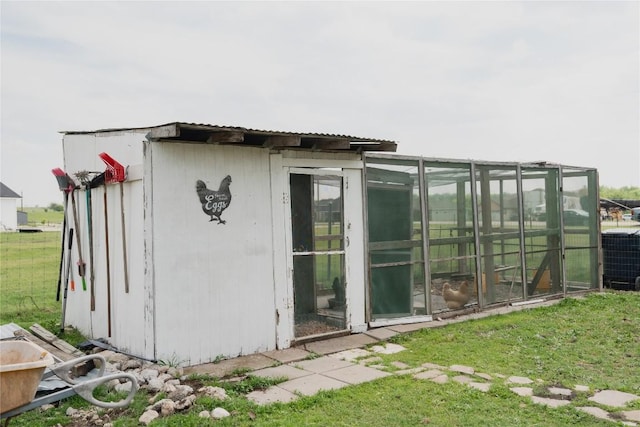 exterior space featuring cooling unit and an outdoor structure