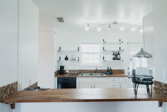 kitchen featuring butcher block countertops, a sink, and dishwasher