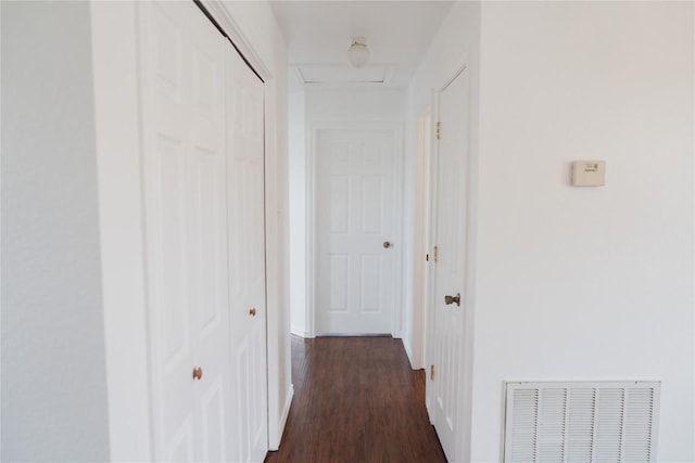 hallway with dark wood finished floors and visible vents