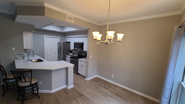 6000 Shepherd Mountain Cv Unit 710, Austin, TX 78730 - kitchen with a sink, stainless steel appliances, white cabinets, a breakfast bar area, and light wood-type flooring
