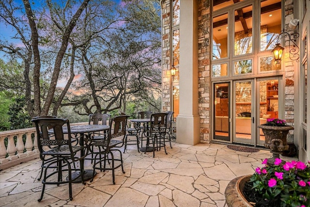 4646 Rockcliff Rd, Austin, TX 78746 - patio terrace at dusk with outdoor dining area and a patio area