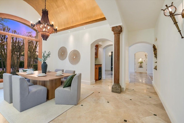4646 Rockcliff Rd, Austin, TX 78746 - dining space with arched walkways, high vaulted ceiling, a chandelier, and beverage cooler