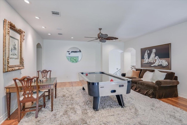 4646 Rockcliff Rd, Austin, TX 78746 - recreation room featuring arched walkways, light wood-style floors, ceiling fan, and recessed lighting