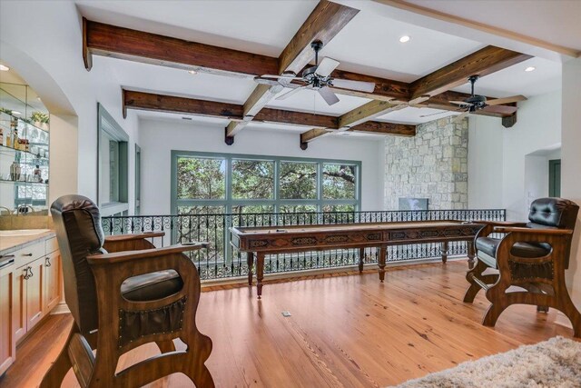 4646 Rockcliff Rd, Austin, TX 78746 - living area featuring a ceiling fan, wood finished floors, beam ceiling, coffered ceiling, and arched walkways