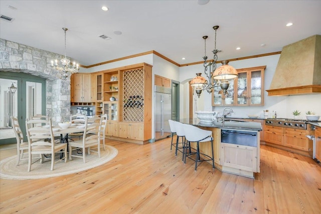 4646 Rockcliff Rd, Austin, TX 78746 - kitchen with a chandelier, premium range hood, stainless steel appliances, a warming drawer, and dark countertops