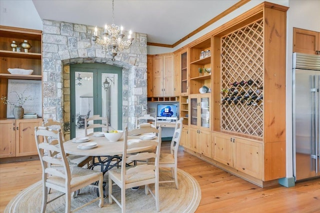 4646 Rockcliff Rd, Austin, TX 78746 - dining room with ornamental molding, light wood finished floors, a chandelier, and built in shelves