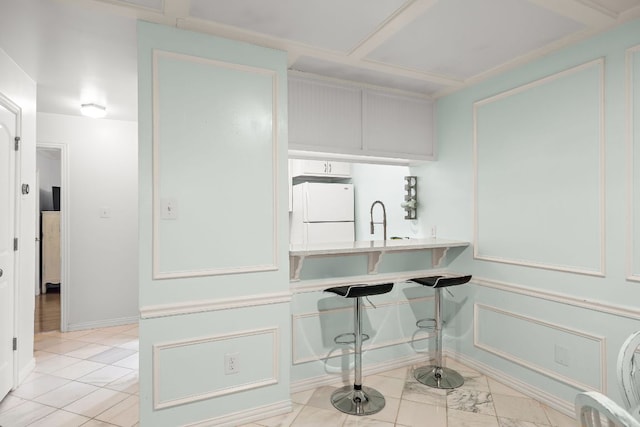 2450 Ashdale Dr Unit D-206, Austin, TX 78757 - kitchen with freestanding refrigerator, light tile patterned flooring, and light countertops