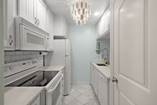 2450 Ashdale Dr Unit D-206, Austin, TX 78757 - kitchen with white appliances, tasteful backsplash, light countertops, and white cabinets