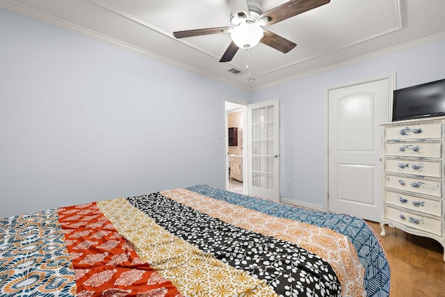 2450 Ashdale Dr Unit D-206, Austin, TX 78757 - bedroom featuring wood finished floors, ornamental molding, ensuite bathroom, and ceiling fan