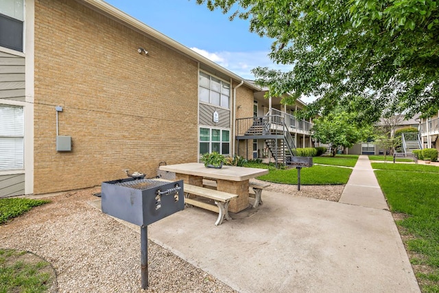 2450 Ashdale Dr Unit D-206, Austin, TX 78757 - view of community with stairs, a lawn, and a patio area