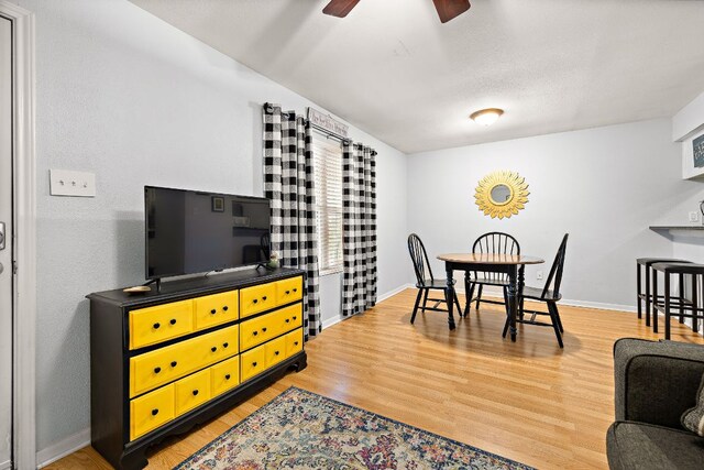 2450 Ashdale Dr Unit B-211, Austin, TX 78757 - dining room featuring baseboards, light wood-style flooring, and ceiling fan