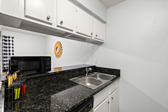 2450 Ashdale Dr Unit B-211, Austin, TX 78757 - kitchen with black microwave, a sink, white cabinets, and dark countertops