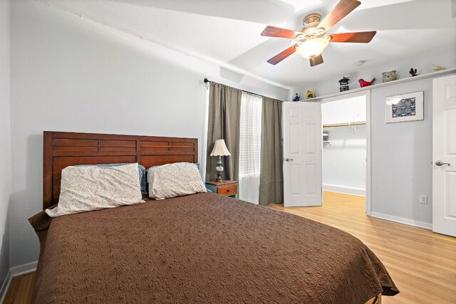 2450 Ashdale Dr Unit B-211, Austin, TX 78757 - bedroom with baseboards, a ceiling fan, and wood finished floors