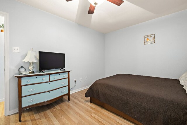 2450 Ashdale Dr Unit B-211, Austin, TX 78757 - bedroom with a ceiling fan, baseboards, and wood finished floors