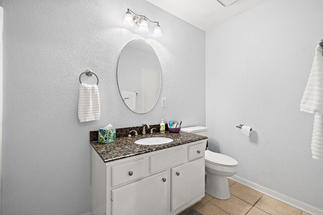 2450 Ashdale Dr Unit B-211, Austin, TX 78757 - half bath featuring toilet, tile patterned floors, baseboards, and vanity