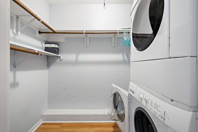 2450 Ashdale Dr Unit B-211, Austin, TX 78757 - laundry area with stacked washer and dryer, laundry area, baseboards, and wood finished floors