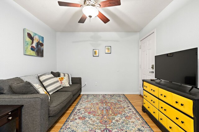 2450 Ashdale Dr Unit B-211, Austin, TX 78757 - living area with light wood-style floors, a ceiling fan, and baseboards