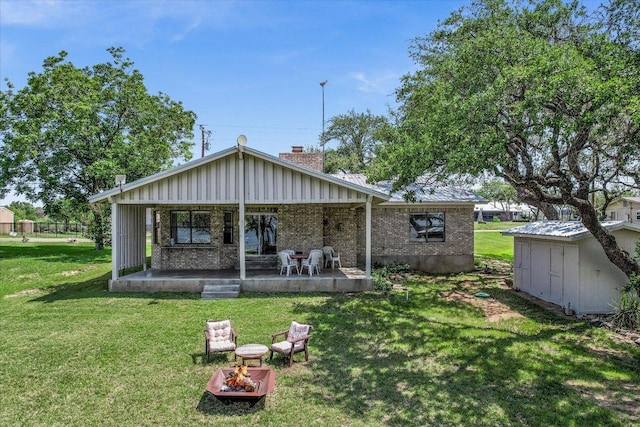 1710 County Road 128, Burnet, TX 78611 - back of property with a lawn, a chimney, brick siding, and a fire pit